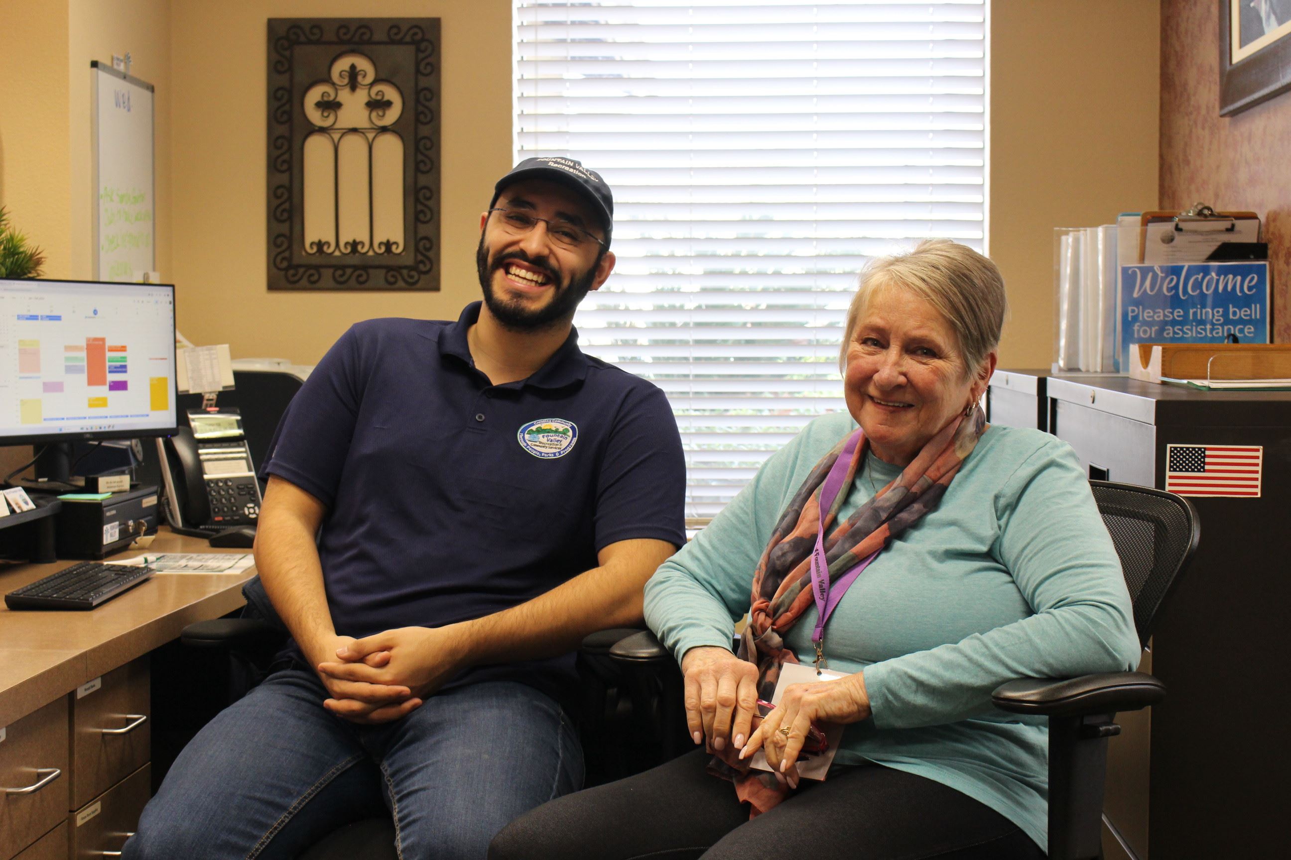 Staff sitting next to volunteer