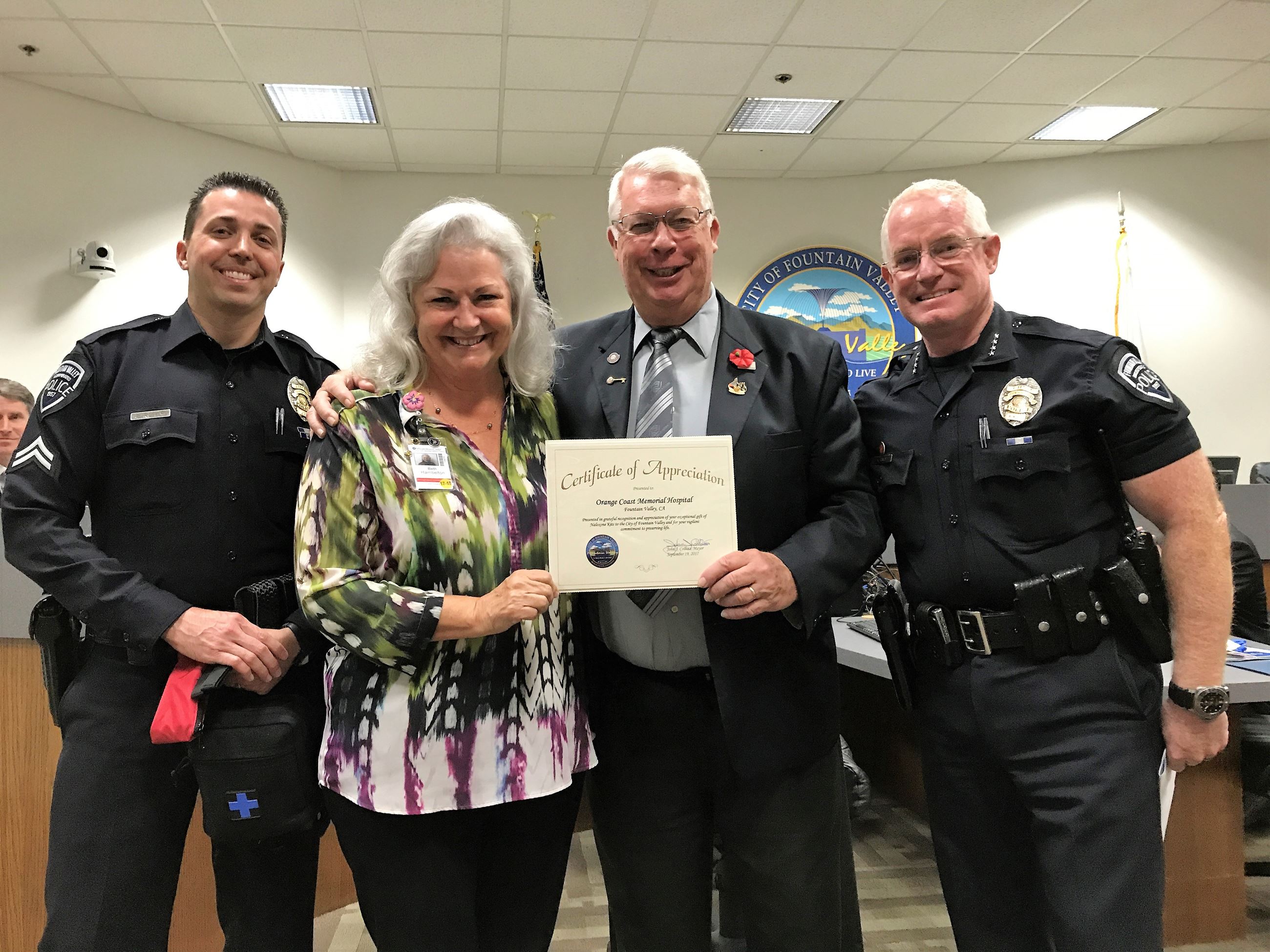 Beth Hambelton accepts the certificate of recognition.