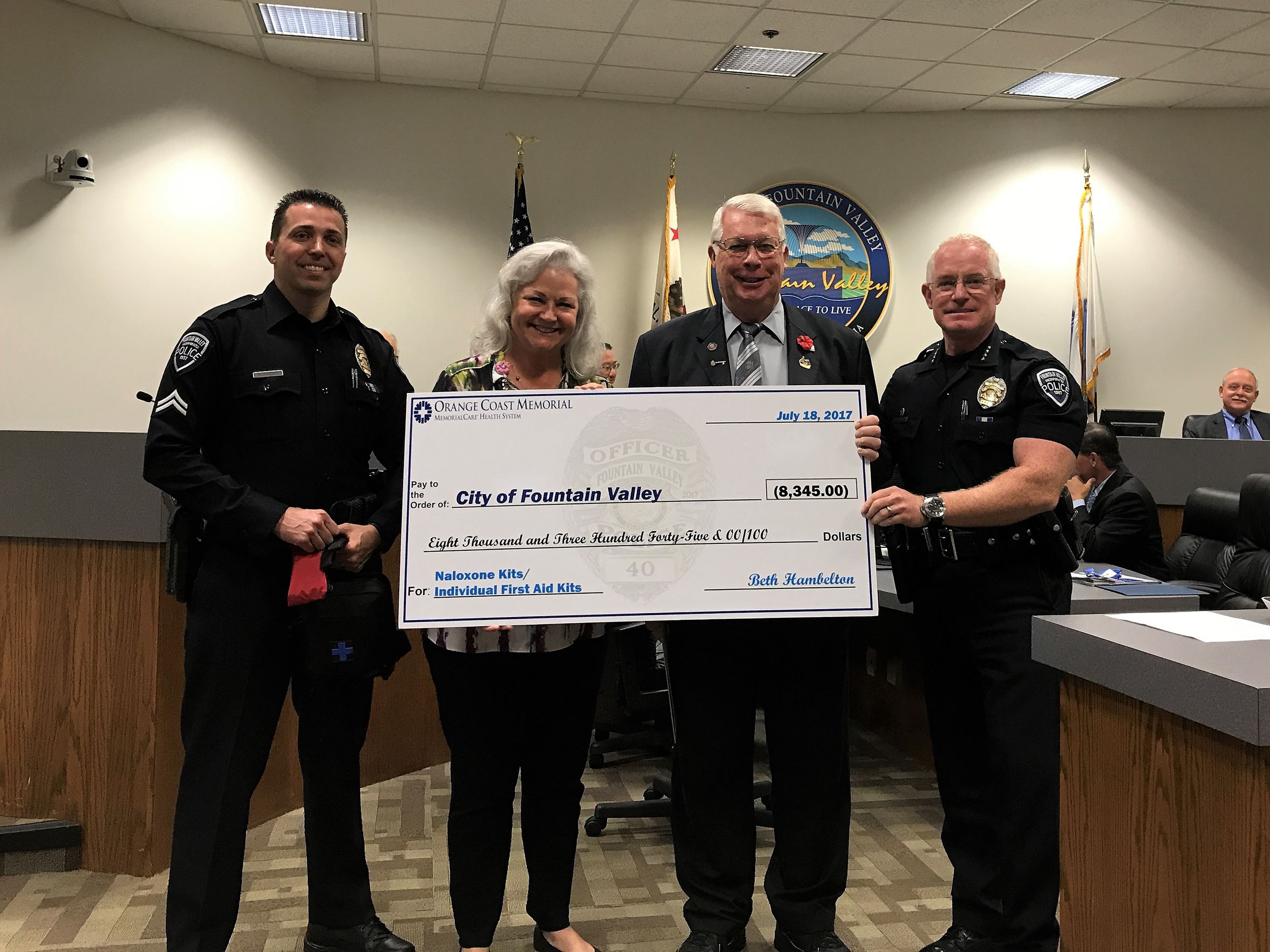 Beth Hambelton accepts the certificate of recognition.