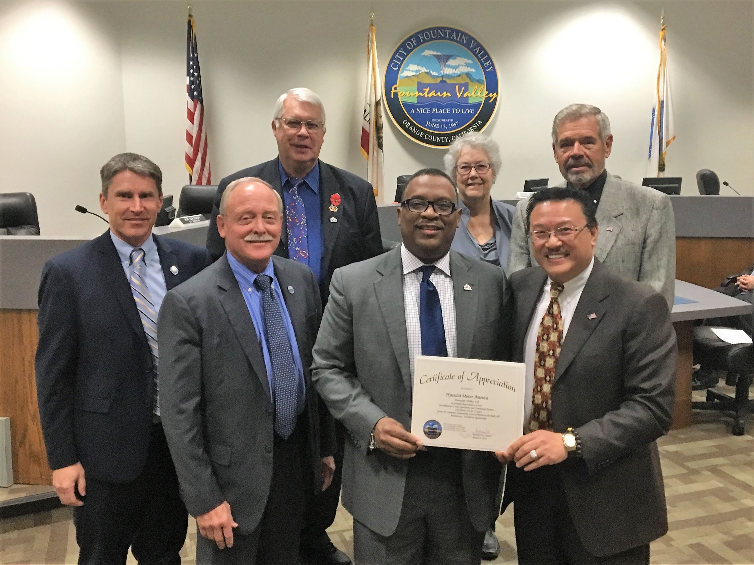 Zafar Brooks accepts the certificate of recognition.